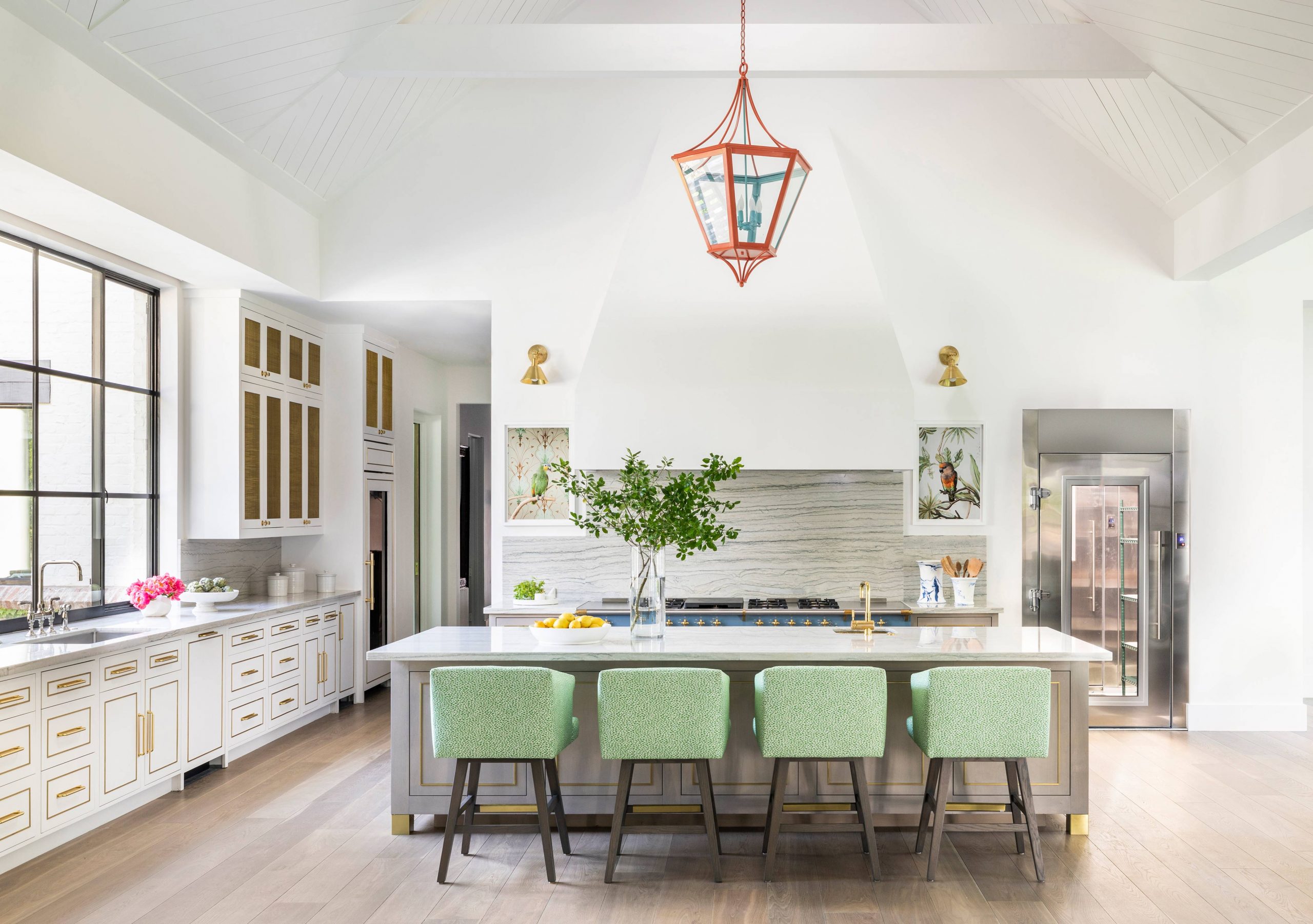 white kitchen with wood floors and marble island - Creative Tonic