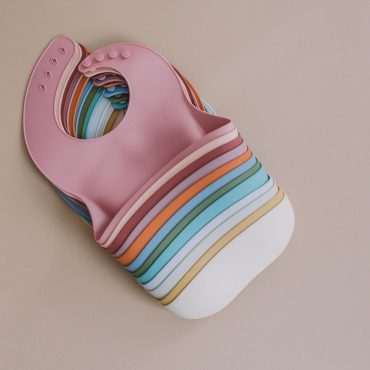 Stack of Multi-Colored Silicone Bibs