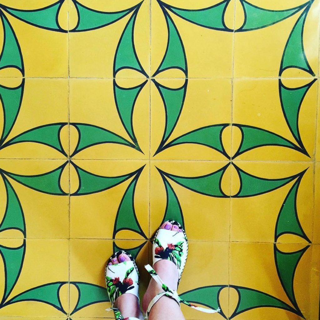 Espadrilles against yellow and green tile at Hotel Saratoga