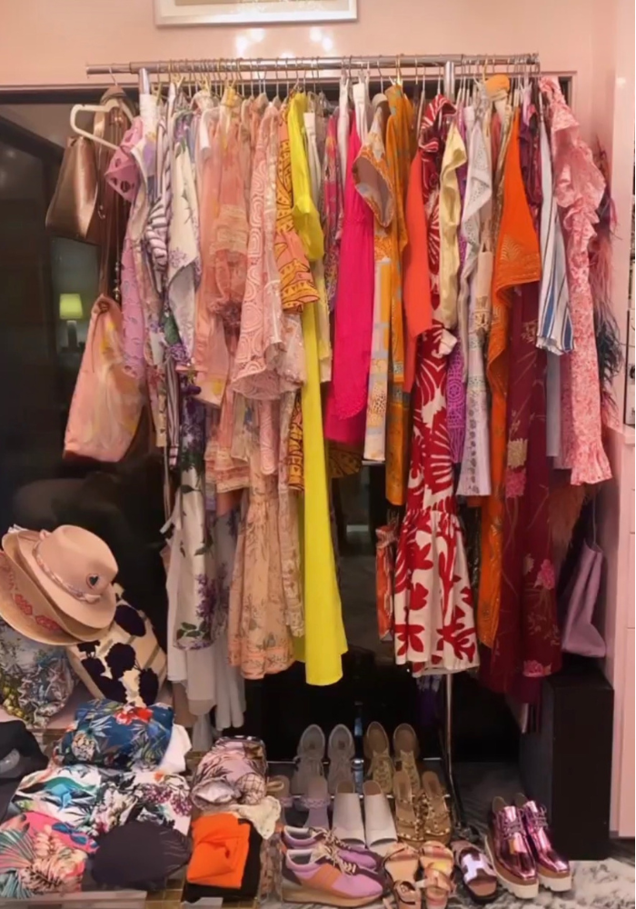 Photo of brightly colored clothing hanging from racks