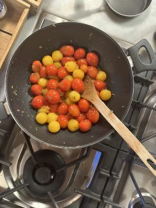 cooking fresh tomatoes from tuscan villa's garden for dinner
